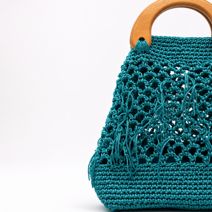 Borsa artigianale Tonda Iblea verde acqua con lavorazione traforata e manico effetto legno